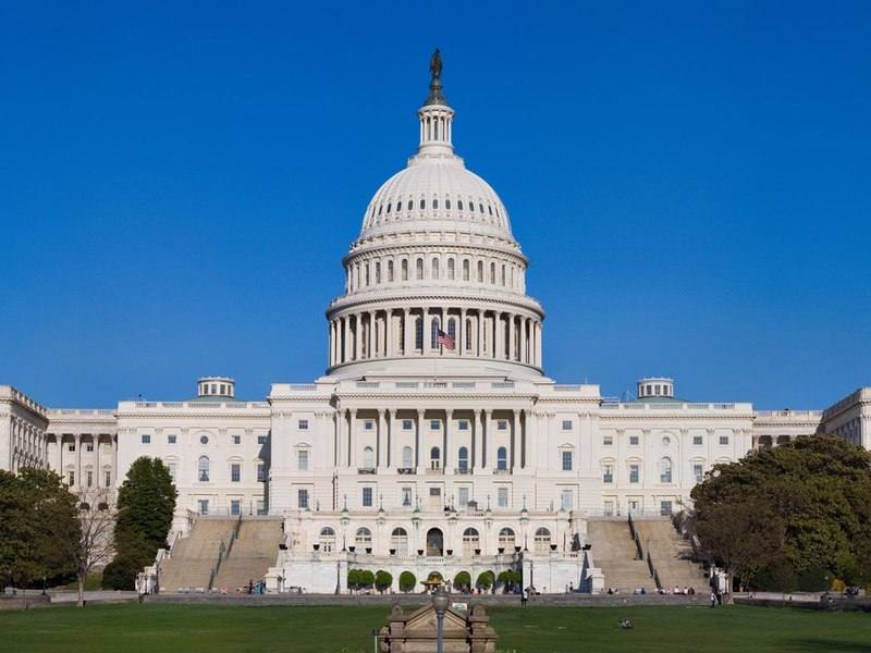 The west front of the United States Capitol under a clear sky