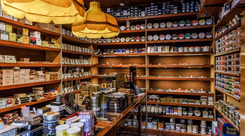 Shelves of pipe tobacco tins and cigar boxes inside a traditional German tobacconist