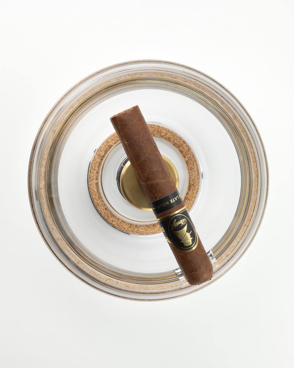 The Murmmr crystal base seen from above, with a cigar laid across its channel and the cork ring visible
