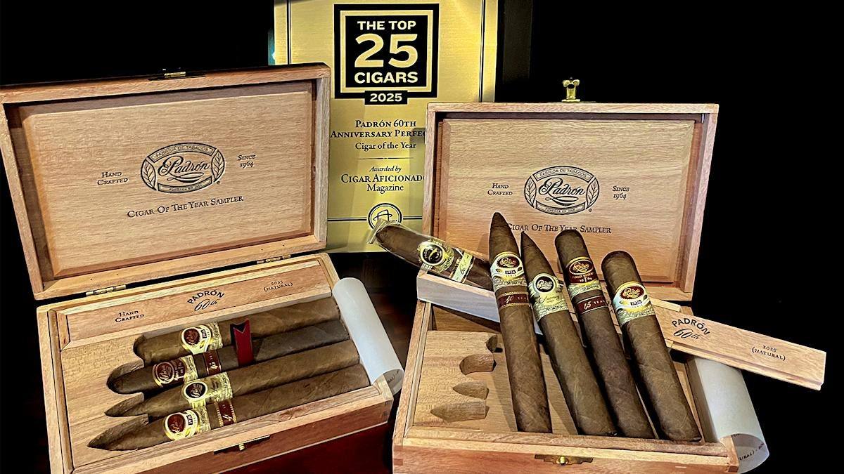 Two open Padron Cigar of the Year Sampler boxes with five champion cigars, in front of a Top 25 Cigars 2025 plaque