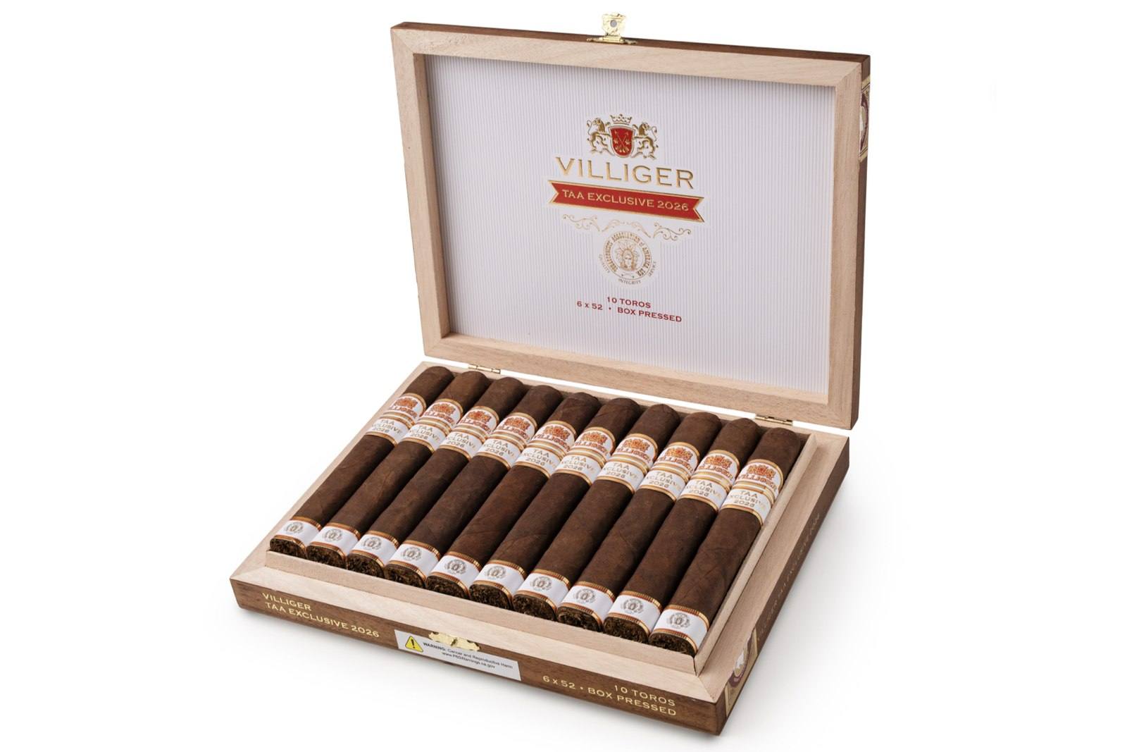 An open wooden box of ten Villiger TAA Exclusive 2026 box-pressed toro cigars with white and gold bands