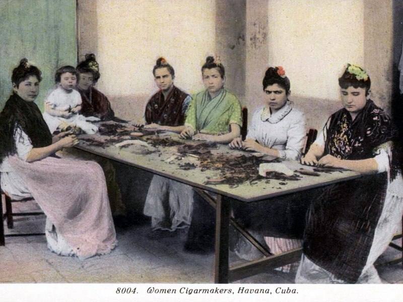 Women cigar makers rolling at a table in Havana