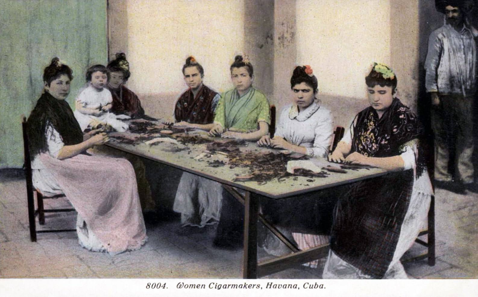 Women cigar makers rolling at a table in Havana